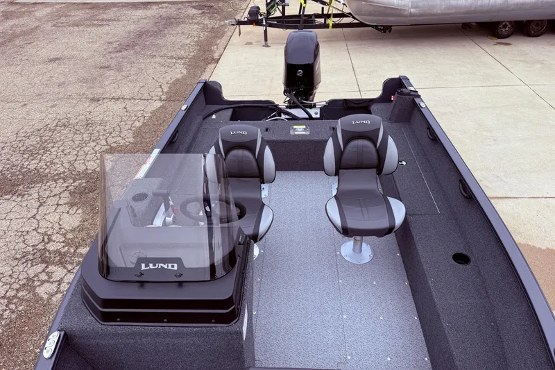 Slide: The Image of 2026 Lund 1650 Rebel XL SS boat interior with two seats and steering console. - 11