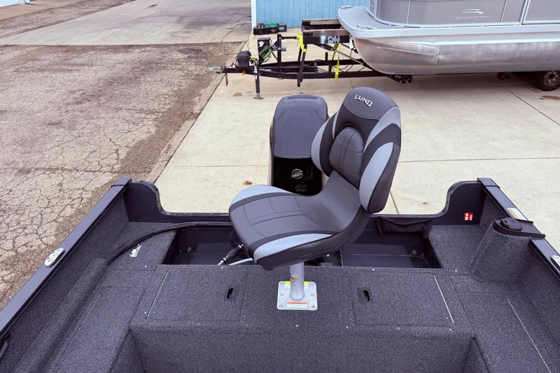 Slide: The Image of 2026 Lund 1650 Rebel XL SS boat interior with swivel seat and motor. - 20