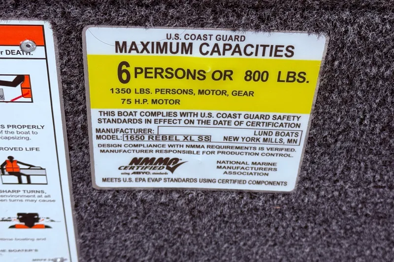 Slide: The Image of U.S. Coast Guard capacity label for 2026 Lund 1650 Rebel XL SS boat, 6 persons or 800 lbs. - 21