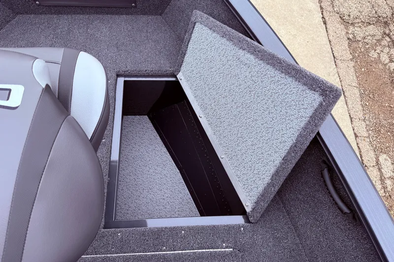 Slide: The Image of Open storage compartment in 2026 Lund 1650 Rebel XL SS boat interior. - 9