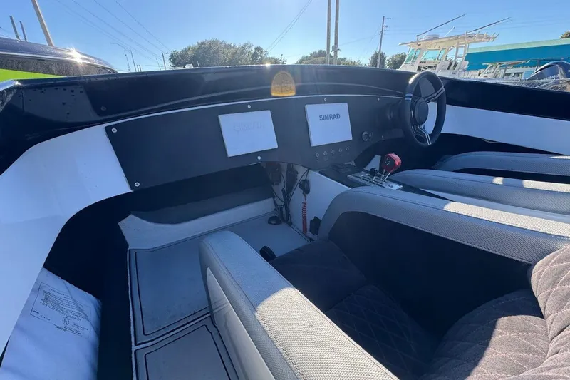 Slide: The Image of Interior of 1988 Activator 22 boat with modern dashboard and steering wheel. - 10