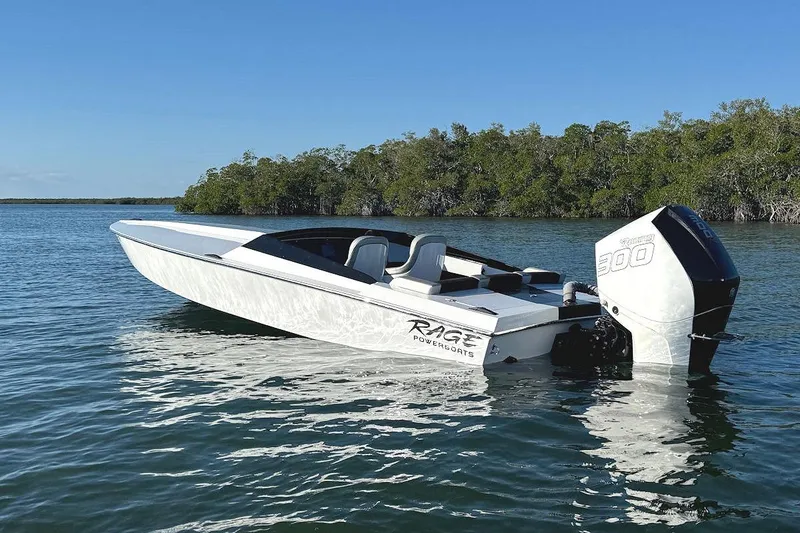 Slide: The Image of 1988 Activator 22 speedboat with outboard motor on calm water, surrounded by trees. - 3