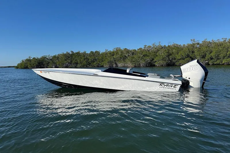 Slide: The Image of 1988 Activator 22 boat on calm water, featuring a powerful outboard motor. - 5