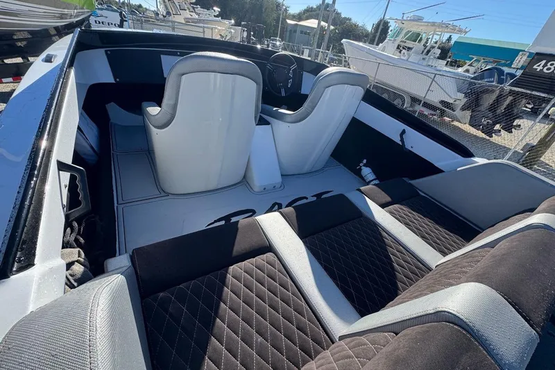 Slide: The Image of Interior of a 1988 Activator 22 boat with modern seating and steering wheel. - 9