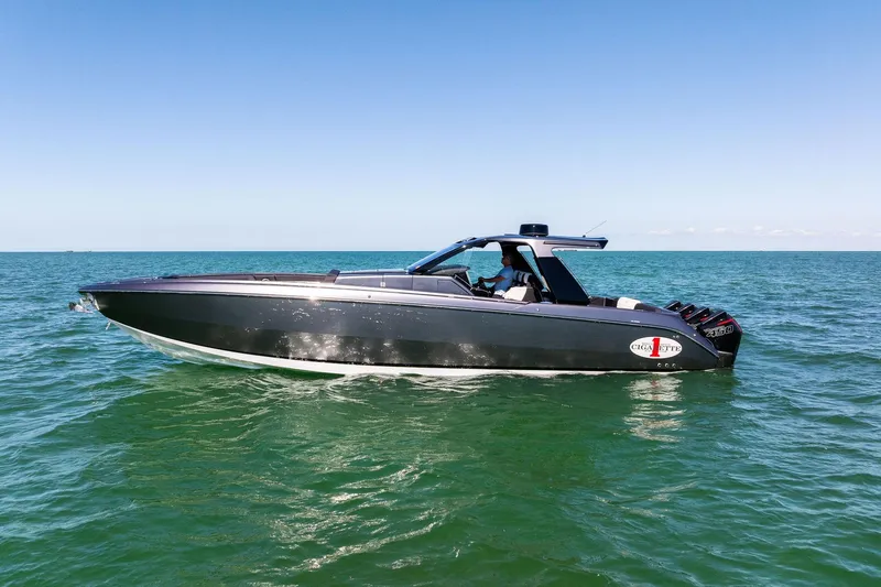 The Image of 2020 Cigarette 42' Auroris boat cruising on open water under clear blue sky. - 0