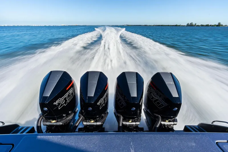 Slide: The Image of 2020 Cigarette 42' Auroris speedboat with four powerful outboard engines on open water. - 11