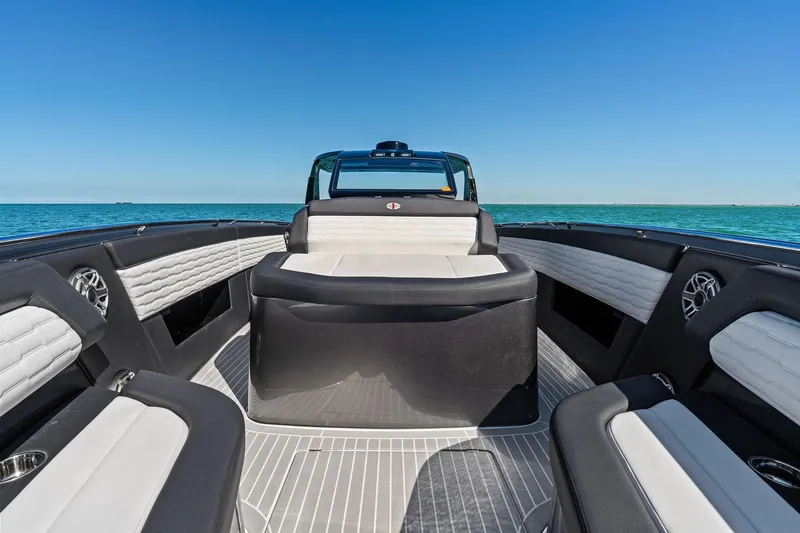 Slide: The Image of 2020 Cigarette 42' Auroris luxury boat interior with sleek seating and ocean view. - 16