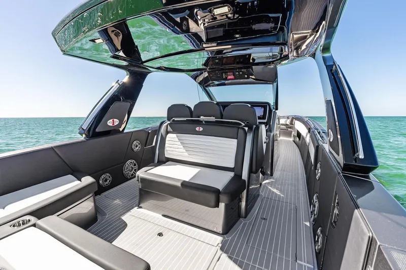 Slide: The Image of 2020 Cigarette 42' Auroris luxury boat interior with sleek seating and ocean view. - 34