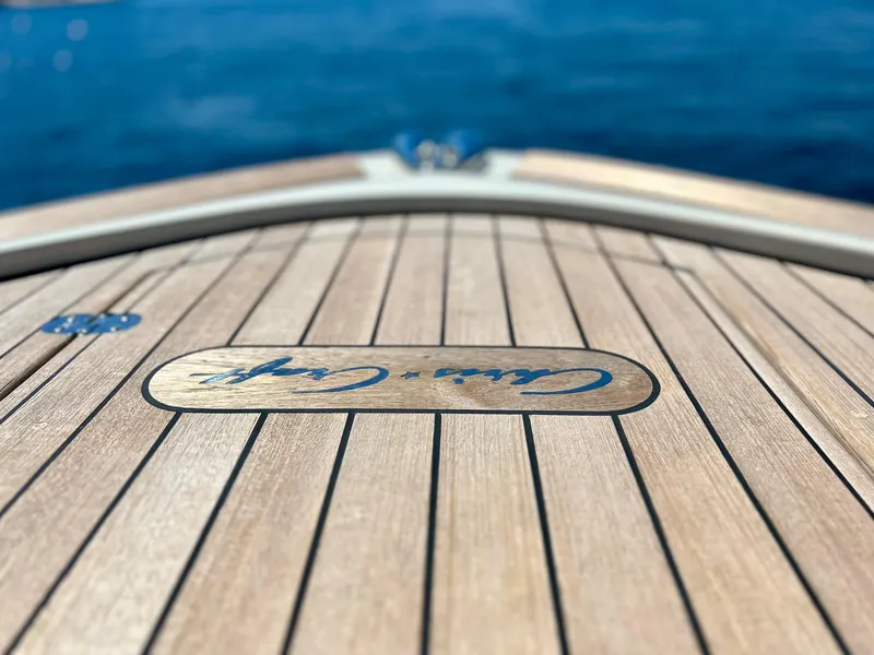 Slide: The Image of 2023 Chris-Craft 35 CALYPSO boat deck with logo, overlooking the ocean. - 12