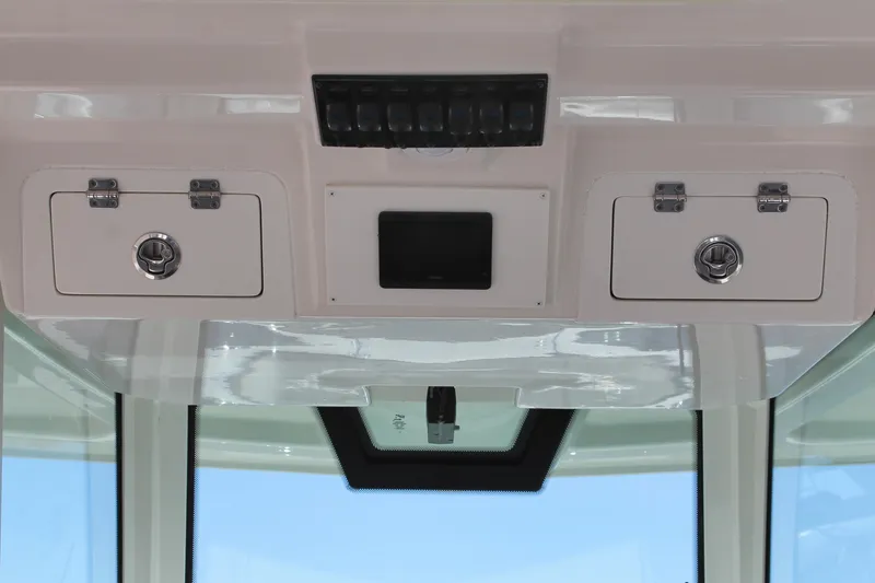 Slide: The Image of Overhead console of 2024 Sailfish 360 CC boat with storage compartments. - 10