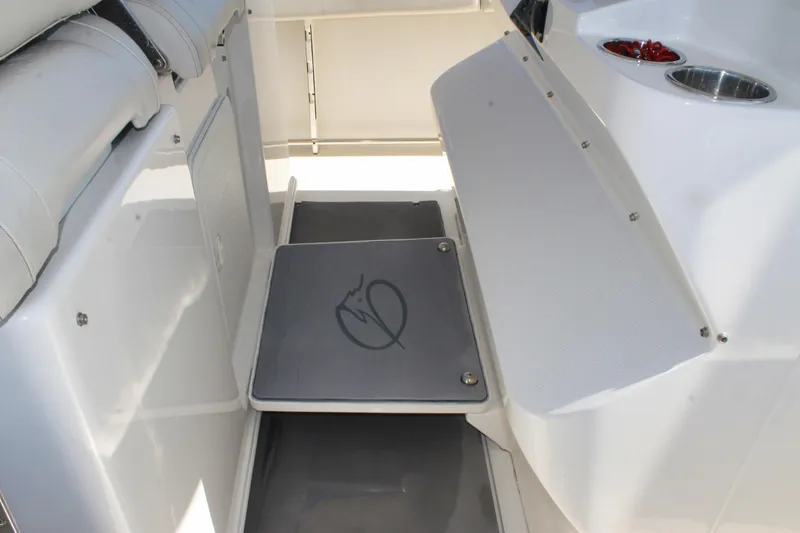Slide: The Image of 2024 Sailfish 360 CC boat interior with foldable seat and cup holders. - 13