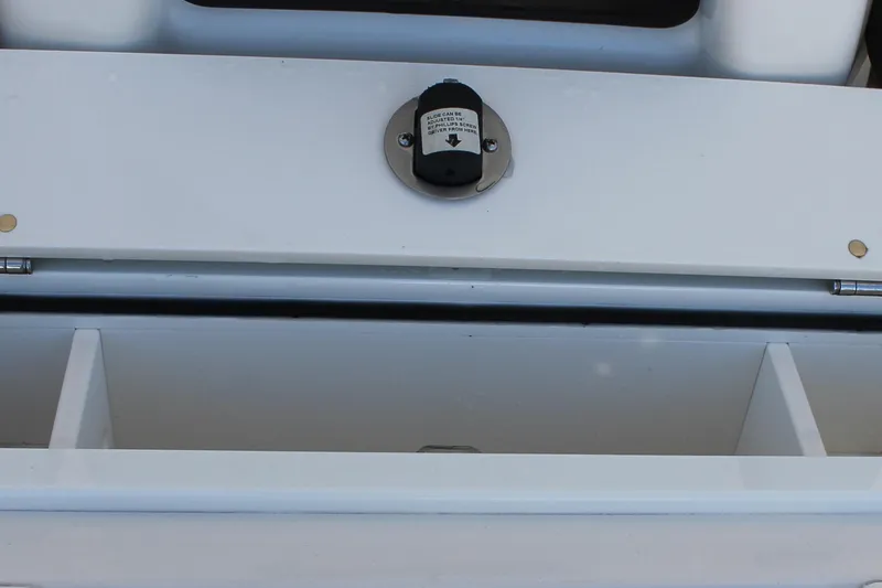 Slide: The Image of 2024 Sailfish 360 CC boat storage compartment with secure latch. - 17