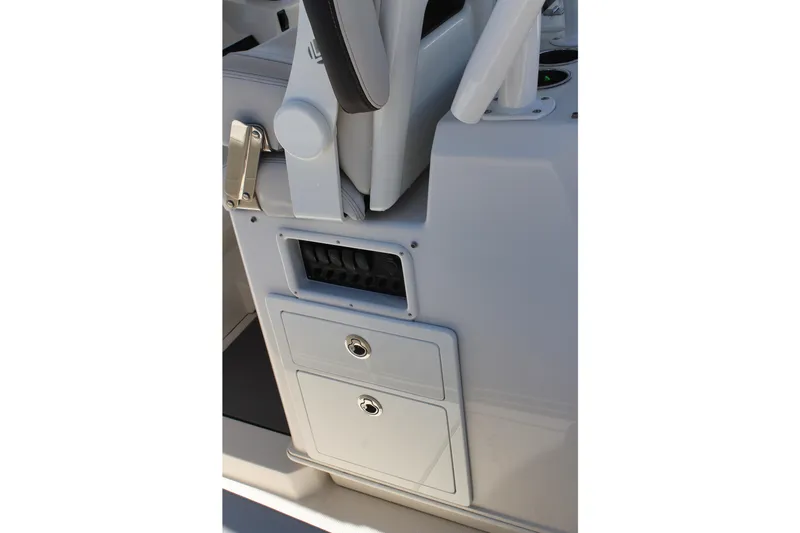 Slide: The Image of 2024 Sailfish 360 CC boat console with storage compartments and seating. - 19