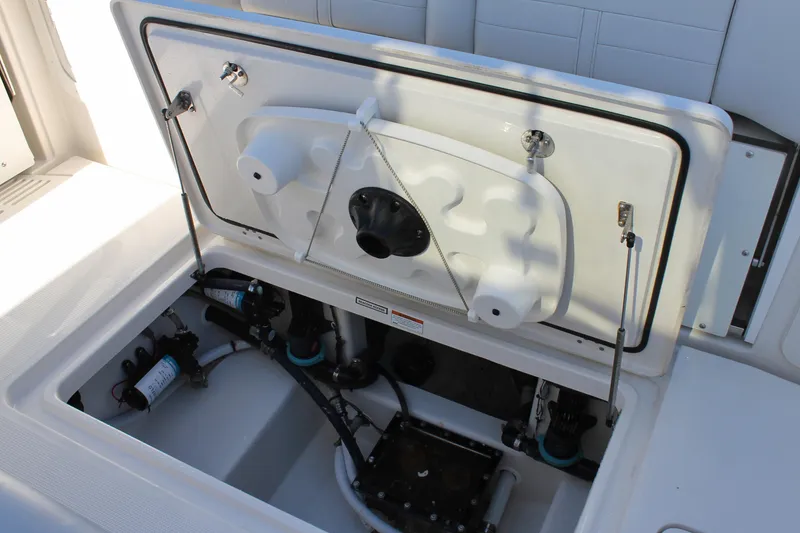 Slide: The Image of 2024 Sailfish 360 CC boat compartment with open hatch, showcasing internal components. - 21