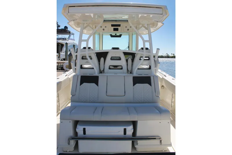 Slide: The Image of 2024 Sailfish 360 CC boat interior with seating and storage, docked by the water. - 23