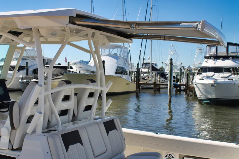 Slide: The Image of 2024 Sailfish 360 CC boat docked at marina with other yachts in background. - 24