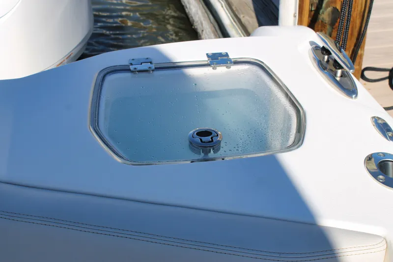 Slide: The Image of 2024 Sailfish 360 CC boat livewell with clear lid and stainless steel fittings. - 25