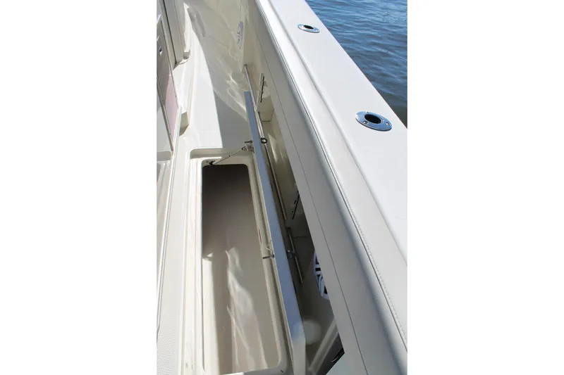 Slide: The Image of 2024 Sailfish 360 CC boat storage compartment with open lid, showcasing sleek design. - 26