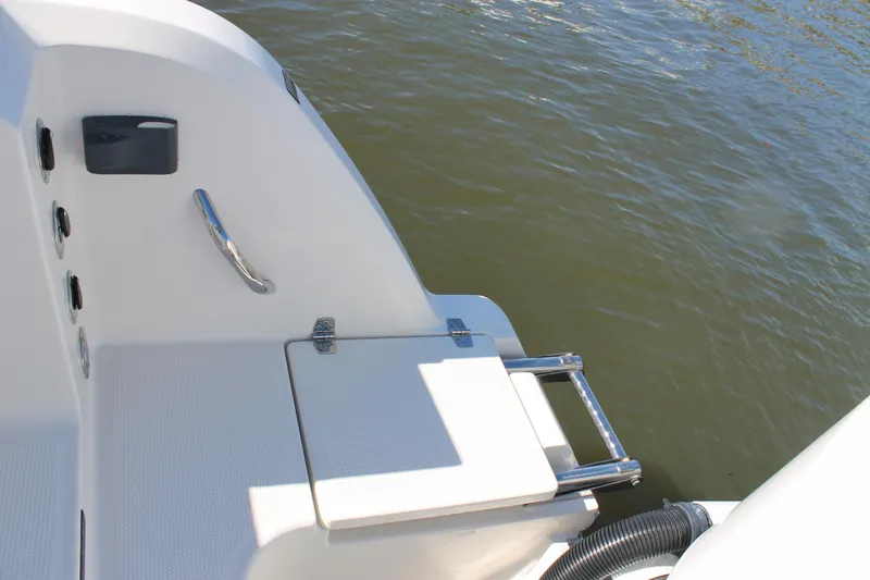 Slide: The Image of 2024 Sailfish 360 CC boat swim platform with ladder on water. - 27
