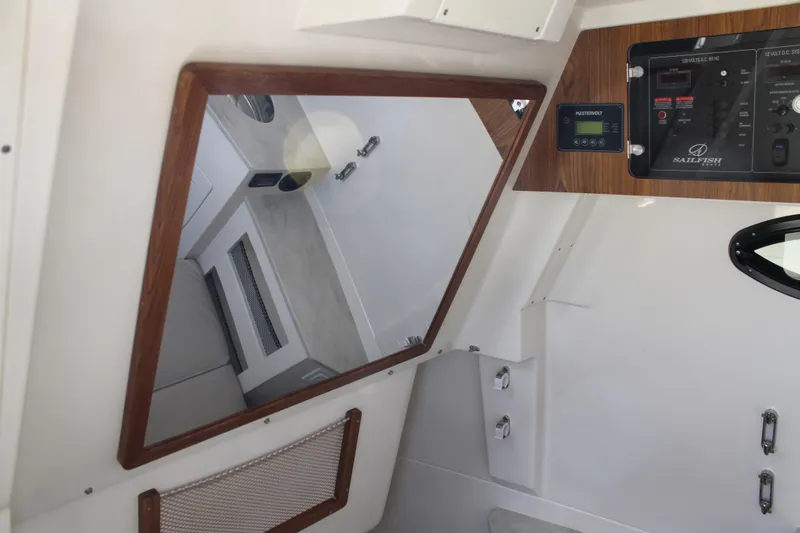 Slide: The Image of 2024 Sailfish 360 CC cabin interior with control panel and mirror. - 31