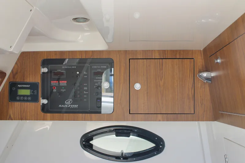 Slide: The Image of 2024 Sailfish 360 CC control panel with wood finish and porthole window. - 32