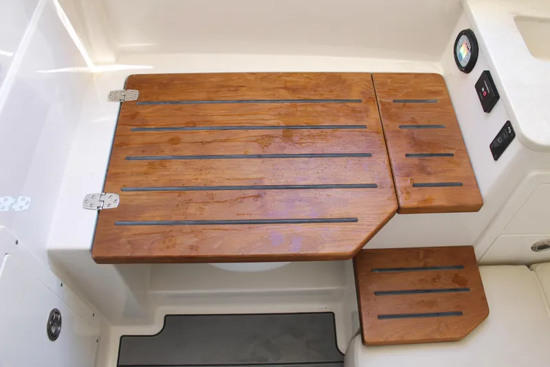 Slide: The Image of 2024 Sailfish 360 CC boat with wooden deck and control panel. - 35