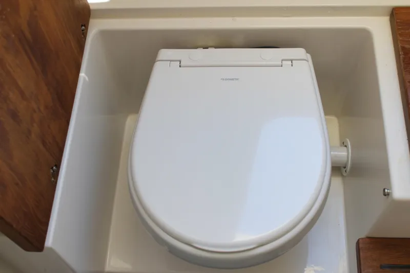 Slide: The Image of 2024 Sailfish 360 CC boat toilet with wooden accents and compact design. - 36