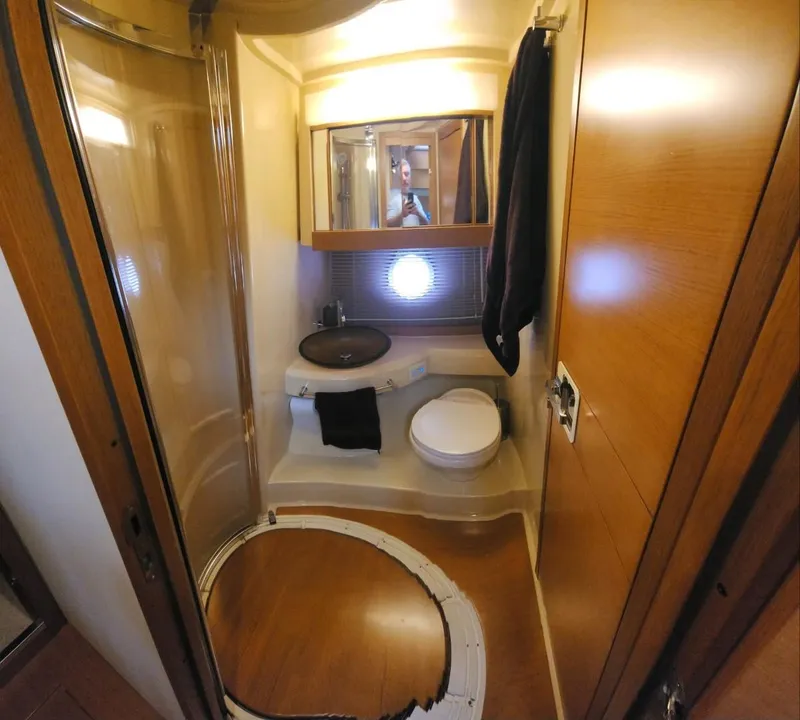 Slide: The Image of Luxurious bathroom in 2013 Azimut 45 Flybridge yacht with modern fixtures and wood accents. - 24