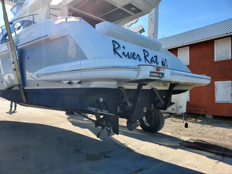 Slide: The Image of 2013 Azimut 45 Flybridge yacht on dry dock, rear view with propellers visible. - 3