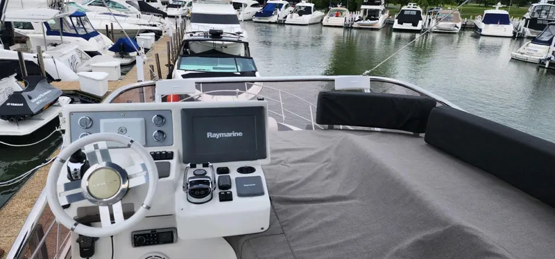 Slide: The Image of Flybridge of 2013 Azimut 45 yacht with Raymarine navigation, docked among other boats. - 6