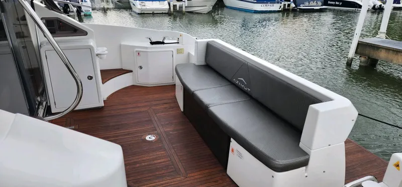 Slide: The Image of Azimut 45 Flybridge 2013 yacht with sleek seating, docked at a marina. - 8