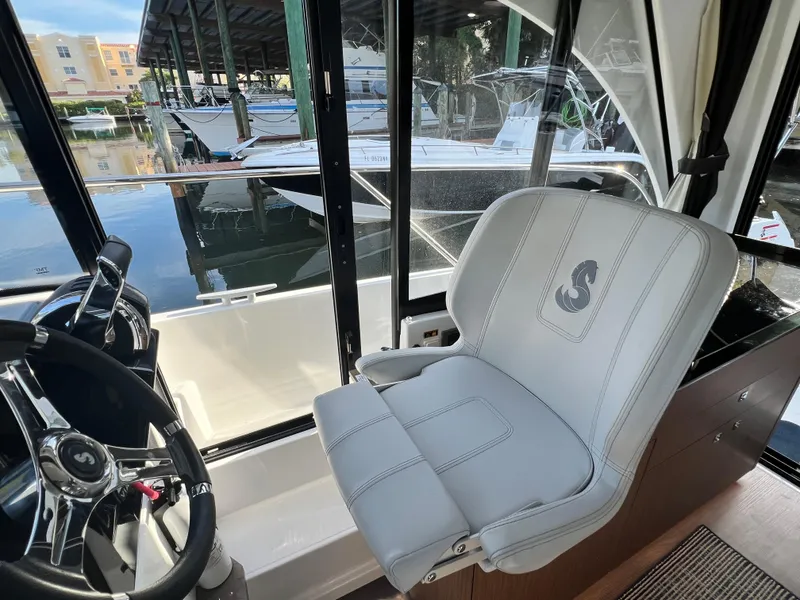 Slide: The Image of Captain's seat and helm of a 2021 Beneteau Antares 9 boat. - 11