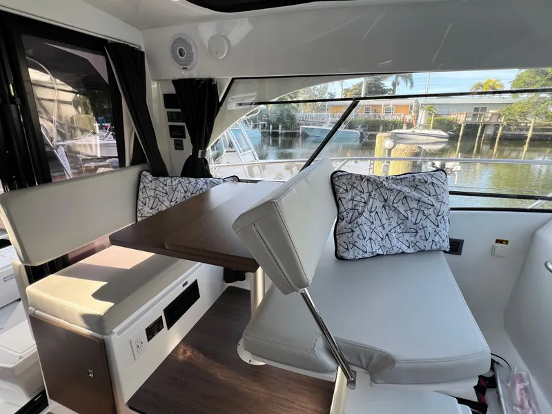 Slide: The Image of Interior of 2021 Beneteau Antares 9 with dining area and waterfront view. - 13