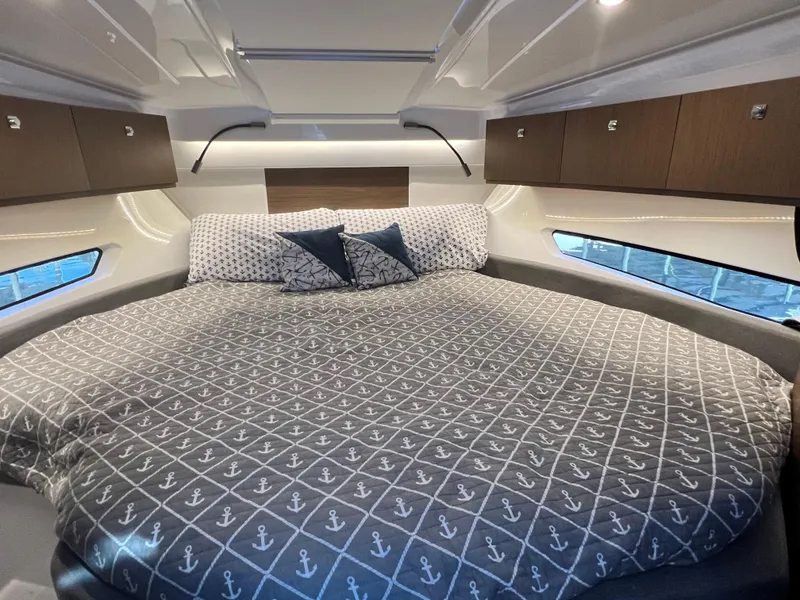 Slide: The Image of Luxurious bedroom in 2021 Beneteau Antares 9 boat with anchor-themed bedding. - 15