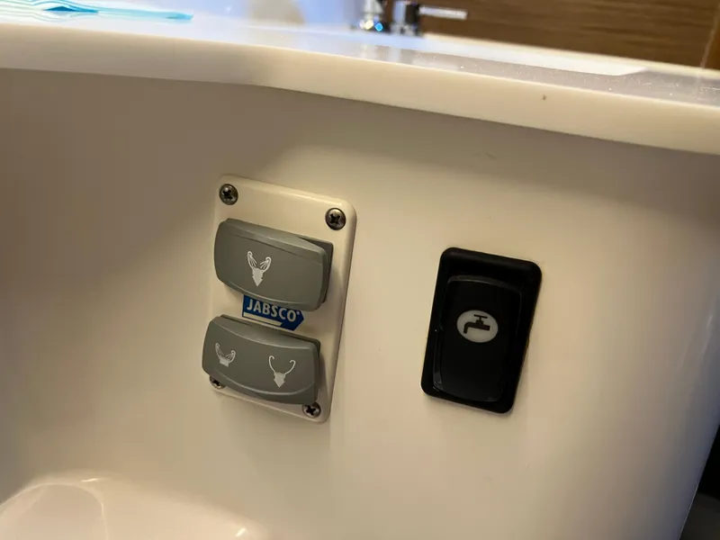 Slide: The Image of Control panel on a 2021 Beneteau Antares 9 boat featuring Jabsco switches. - 23