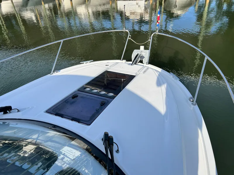 Slide: The Image of 2021 Beneteau Antares 9 boat bow view at marina. - 27
