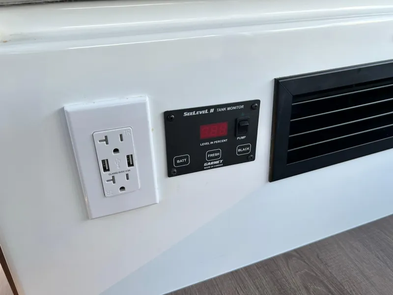 Slide: The Image of Electrical outlet and control panel on 2021 Beneteau Antares 9 boat interior. - 29