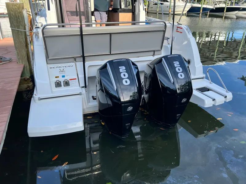 Slide: The Image of 2021 Beneteau Antares 9 with twin outboard engines docked at marina. - 5