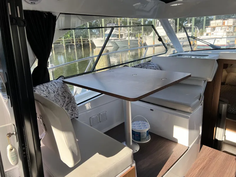 Slide: The Image of Interior of 2021 Beneteau Antares 9 with dining area and large windows. - 7