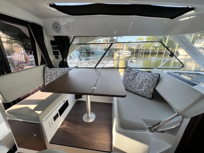 Slide: The Image of Interior of 2021 Beneteau Antares 9 with dining area and waterfront view. - 8