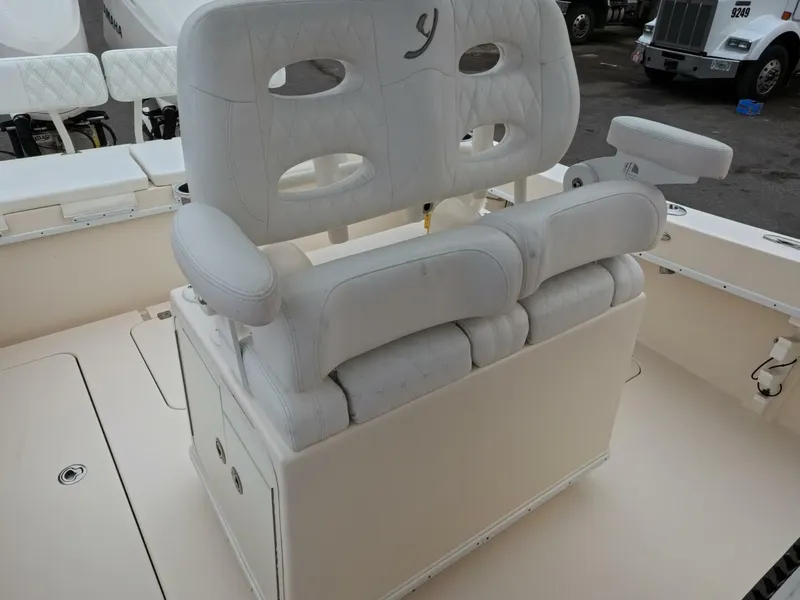 Slide: The Image of 2019 Young Boats 27 model, showcasing sleek deck design and control panel on calm waters. - 17