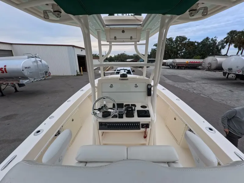 Slide: The Image of 2019 Young Boats 27 on calm water, showcasing spacious deck and sleek design. - 2