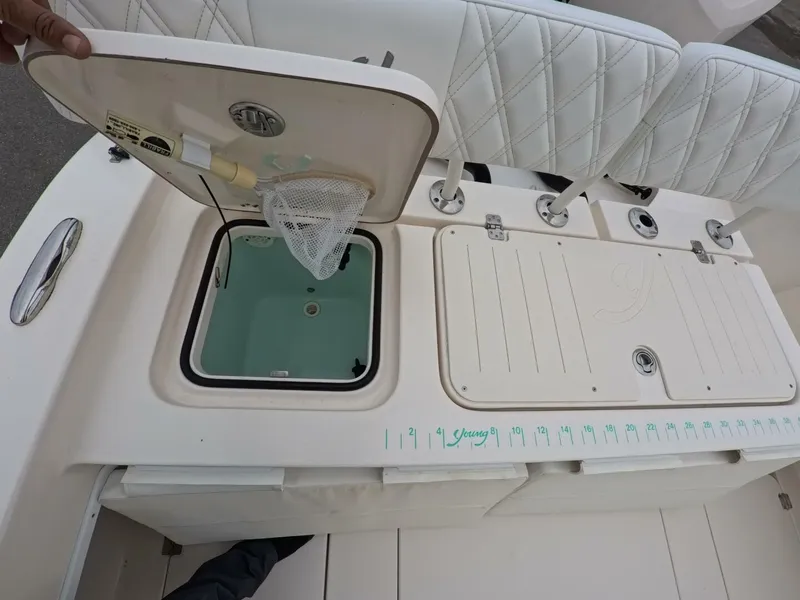 Slide: The Image of 2019 Young Boats 27 model, spacious deck with rod holders and storage, on calm water. - 26