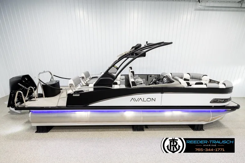 The Image of 2026 Avalon CAT QLS pontoon boat with sleek design and modern features in showroom. - 1