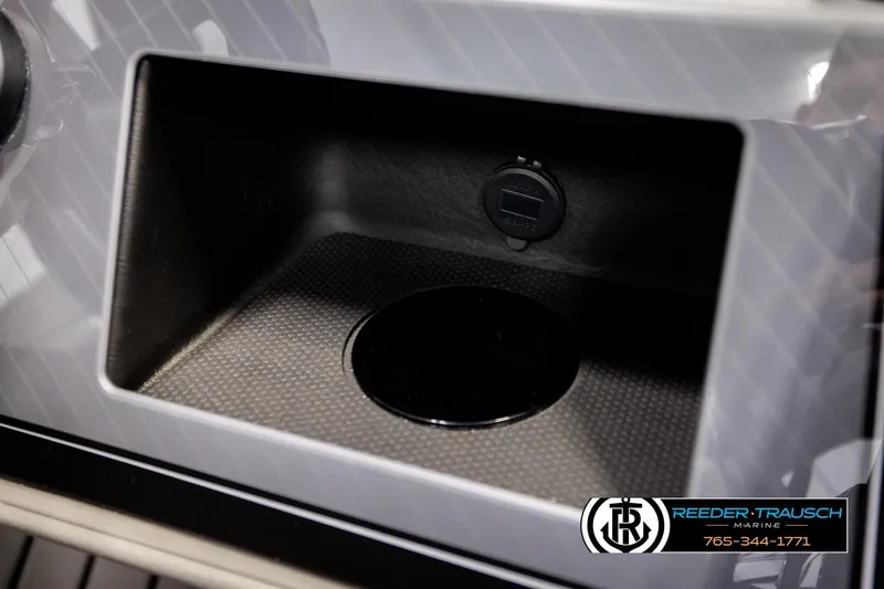 Slide: The Image of Storage compartment in 2026 Avalon CAT QLS boat with USB port, Reeder-Trausch Marine branding. - 39