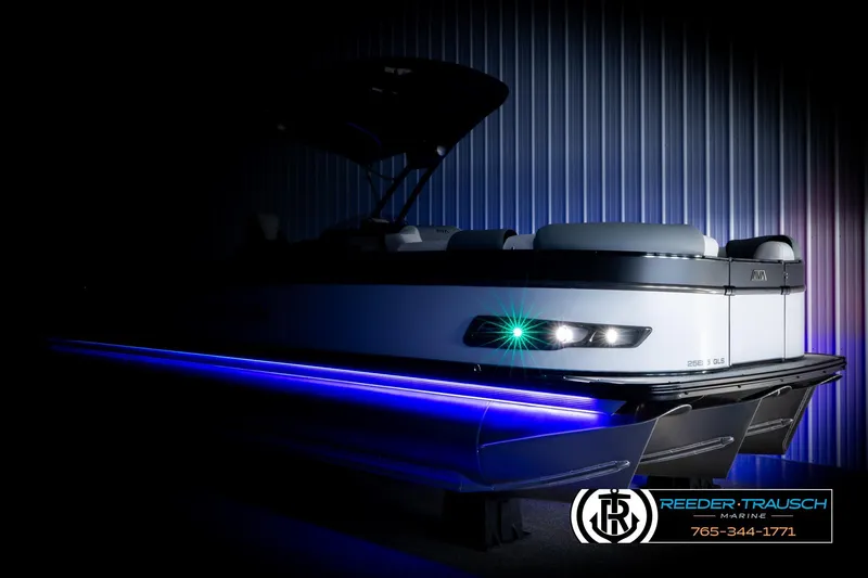 Slide: The Image of Luxurious 2026 Avalon CAT QLS pontoon boat with blue LED lights, showcased by Reeder-Trausch Marine. - 4