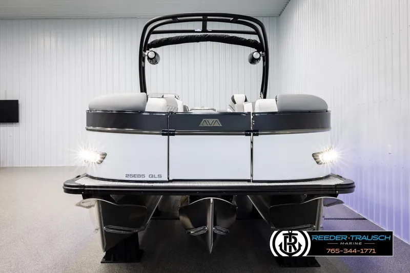 Slide: The Image of 2026 Avalon CAT QLS pontoon boat in showroom, rear view with lights on. - 8