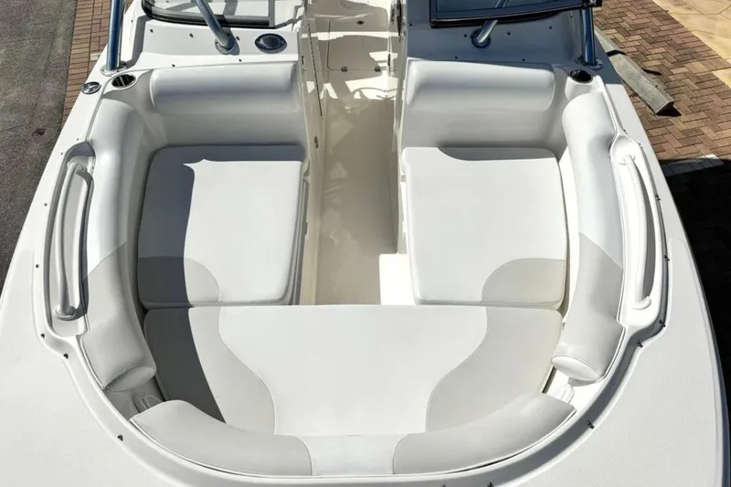 Slide: The Image of 2016 Edgewater 205CX Crossover boat interior with white cushioned seating. - 13