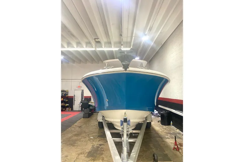 Slide: The Image of 2016 Edgewater 205CX Crossover boat in a garage, front view. - 17