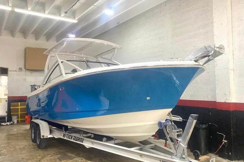Slide: The Image of 2016 Edgewater 205CX Crossover boat in a garage on a trailer. - 19